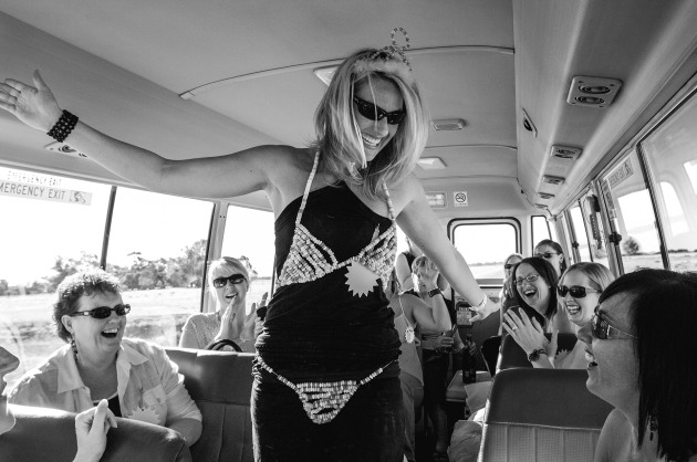 A bride celebrates her Hens Day with friends as they travel on a bus in Northern Victoria &ndash; Australia. Image &copy; Michael Coyne.