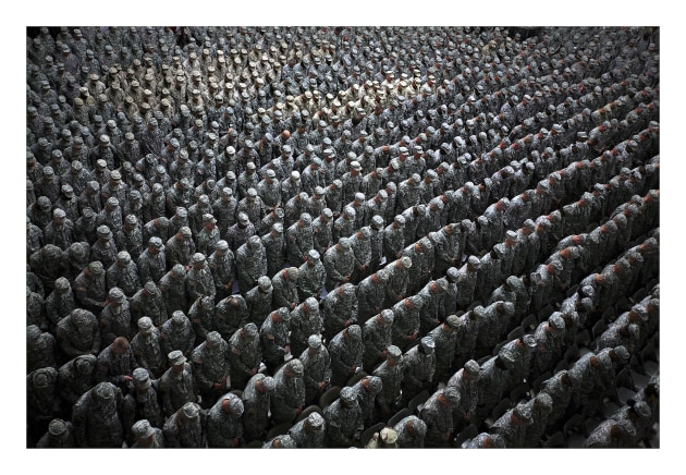 &copy; Ashley Gilbertson/VII Network. 1,215 American soldiers, airmen, Marines and sailors pray before a pledge of enlistment on July 4, 2008, at a massive re-enlistment ceremony at one of Saddam Hussein's former palaces in Baghdad, Iraq 2008, from the Whiskey Tango Foxtrot series, type C photograph, 69 x 94 x 5.5 cm. Courtesy of the artist.