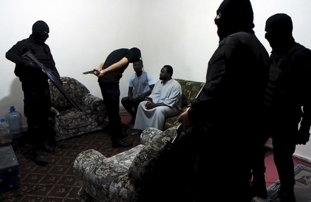 &copy; Samuel Gratacap, courtesy Galerie Les filles du Calvaire, Paris. Search in a house by anti-illegal immigration police, Tripoli, Libya 2016, from the fifty-fifty series 2016, pigment inkjet print, 52.5 x 80.5 cm.