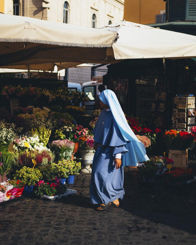 Campo De' Fiori: 
It seems to me that I am the only person in Rome today with nowhere in particular to be. The sun began early, its dreamy heat slowing my blinking. The piazza is being set up around me, everybody is darting across the stage, into their first positions for the days trade to begin. I search for a matching colour to join the vibrant flowers. 
Image: Francesca Donnoli