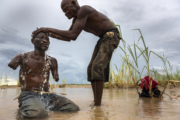 © Brent Stirton. Yusuf Shabani Difika, 41, lost both his arms to a lion attack, in 2005, on a fishing trip in the region of Selous National Park, Tanzania, 4 March 2013.
