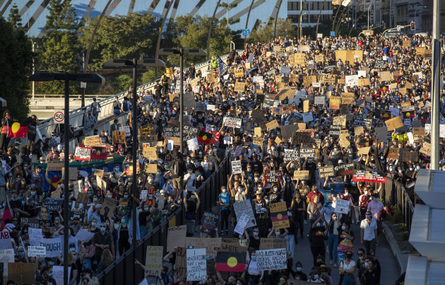 Australians Rally In Solidarity With Black Lives Matter Movement. People march across the Victoria Bridge on June 06, 2020 in Brisbane, Australia. Events across Australia have been organised in solidarity with protests in the United States following the killing of an unarmed black man George Floyd at the hands of a police officer in Minneapolis, Minnesota and to rally against aboriginal deaths in custody in Australia.