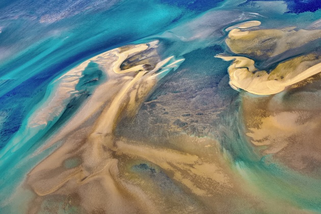 Island style. This was taken on an exploratory aerial trip to a remote island chain way off the western Kimberley Coastline in West Australia. We had to time it with an extremely low tide to be able to reach into all the reef structures visually as most of it is generally underwater The bluest blues I’ve ever seen in my life out this way… Image: Paul Hoelen