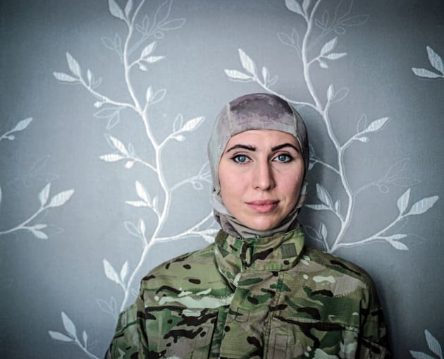 July 2015, Odessa. Amina Okuyeva poses for the photo in a flat she shares with her mother and son. Amina left war-torn Chechnia and moved to Odessa where she studied and become a doctor. She was on Maidan from December 2014 working as a medical volunteer. In that time her husband was in prison accused of the attempt to kill Russian President V. Putin. After Euromaidan revolution he was pardoned  and together with Amina joined "international peacekeeping battalion" of volunteers to support Ukraine in fighting against the pro-Russian insurgency. Presently,  she is a fighter in the Brigade named after first Chechen president, Dzhokhar Dudayev. She also serves as a Brigade  press officer. &copy; Justyna Mielnikiewicz.