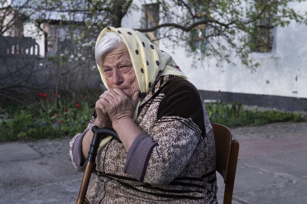 © Stephen Dupont. Halyna (73) in the village of Andriivka, Ukraine. She and her family survived the occupation by Russians, by living in their basement. Halyna often negotiated with the Russian soldiers for permission to get water from the well outside her yard as locals were not allowed to leave their yards.