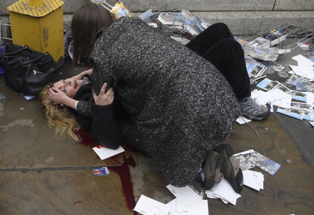 Witnessing the Immediate Aftermath of an Attack in the Heart of London. World Press Photo of the Year Nominee. &copy; Toby Melville. 
A passerby comforts an injured woman after Khalid Masood drove his car into pedestrians on Westminster Bridge in London, UK, killing five and injuring multiple others.
Commissioned by Reuters.