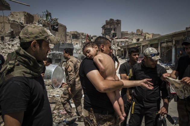 The Battle for Mosul. World Press Photo of the Year Nominee. &copy; Ivor Prickett. 
An unidentified young boy, who was carried out of the last ISIS-controlled area in the Old City by a man suspected of being a militant, is cared for by Iraqi Special Forces soldiers.
Commissioned by The New York Times.