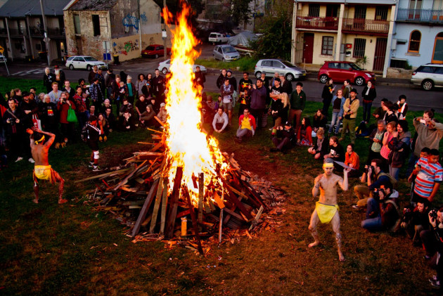 Redfern Aboriginal Tent Embassy, Sydney, 2015.
Indigenous people from the Redfern Aboriginal Tent Embassy (RATE) perform a fire and dancing ceremony with supporters in opposition to a controversial multi-million dollar development by the Aboriginal Housing Company (AHC).
The Redfern Aboriginal Tent Embassy, which occurred continuously over fifteen months, was created on 26th May 2014 in the heart of inner-city Sydney on the historical site of the first land granted by the Australian Government to Aboriginal people. Indigenous people from around Australia followed the unfolding protest primarily on social media and in the mainstream news. Image: Glenn Lockitch.